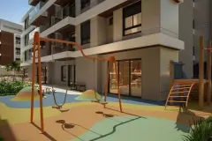 Playground com balanços e escorregador em metal laranja sobre piso emborrachado colorido — Villa Maggiore em João Paulo, Florianópolis