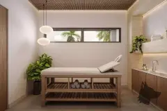 Sala de massagem com maca, luminária pendente, bancada com toalhas e janela com vista para jardim — Villa Maggiore em João Paulo, Florianópolis