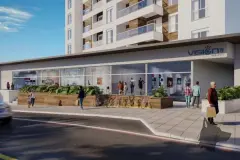 Térreo comercial do Vision 1617 com fachada envidraçada, bicicletário e movimento de pedestres — Vision 1617 em Saco Grande, Florianópolis