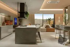 Sala e cozinha integradas com ilha de pedra, coifa preta, sofá, banquetas e portas de vidro abertas para jardim — Viva Balneário Estreito em Balneário, Florianópolis