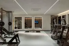 Academia equipada com rack de barras, bancos de musculação, esteiras e espelhos com iluminação embutida — Viva Balneário Estreito em Balneário, Florianópolis