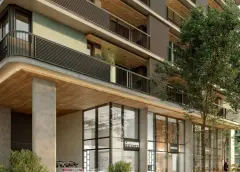 Térreo do edifício com lojas Lavender Jewelry e Estelle, marquise de madeira e varandas com vegetação acima — Viva Balneário Estreito em Balneário, Florianópolis