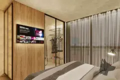 Dormitório com cama, TV embutida em painel de madeira, guarda-roupa de vidro com roupas visíveis e janela com cortina — Viva Balneário Estreito em Balneário, Florianópolis