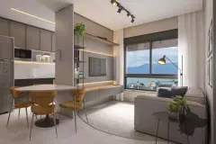Sala de estar integrada com cozinha americana, mesa de jantar, sofá cinza, estante com TV e janela com vista para as montanhas — VYU One em Coqueiros, Florianópolis