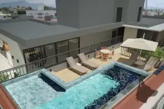 Piscina e área de lazer no rooftop com deck de madeira, espreguiçadeiras e guarda-sol, vista aérea — VYU One em Coqueiros, Florianópolis