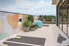 Espaço zen ao ar livre com tatames de yoga, bola de pilates, vasos com plantas e mural floral na parede — VYU One em Coqueiros, Florianópolis