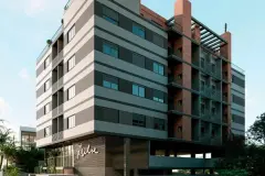 Fachada do edifício VYU Pulse com revestimento de tijolinho aparente e pergolado metálico no rooftop — VYU Pulse em Coqueiros, Florianópolis