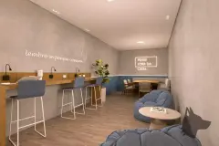 Coworking com bancada de trabalho, banquetas, poltronas puf azuis e letreiros neon motivacionais — VYU Pulse em Coqueiros, Florianópolis