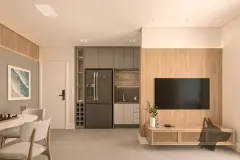 Sala de estar com TV em painel de madeira, sofá, mesa com adega e cozinha integrada — VYU Pulse em Coqueiros, Florianópolis