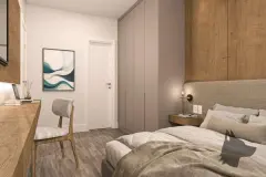 Suíte com cama de casal, cabeceira estofada cinza, guarda-roupa embutido e escrivaninha — VYU Pulse em Coqueiros, Florianópolis