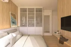 Suíte com cama de casal, closet com porta telada, painel de TV e revestimento em madeira — VYU Pulse em Coqueiros, Florianópolis