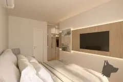 Suíte com cama, painel de TV em madeira com iluminação LED e closet aberto ao fundo — VYU Pulse em Coqueiros, Florianópolis