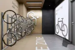 Bicicletário com suportes verticais, decoração temática ciclismo e piso marcado E.ZONE — Yuná Blue View em Campeche, Florianópolis
